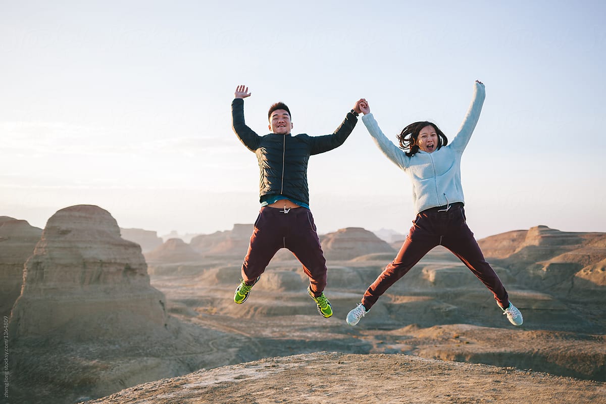 young couple jumping in the Ghost City,Xinjiang