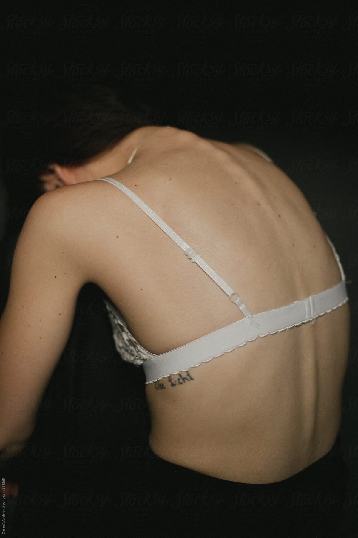 Skinny Girl Wearing White Bra With Boney Spine Showing by Stocksy  Contributor Jess Craven - Stocksy