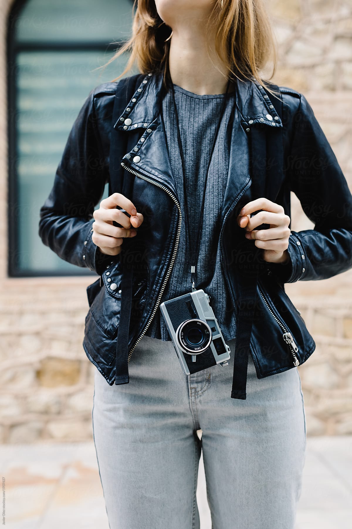 Crop trendy woman with backpack and camera