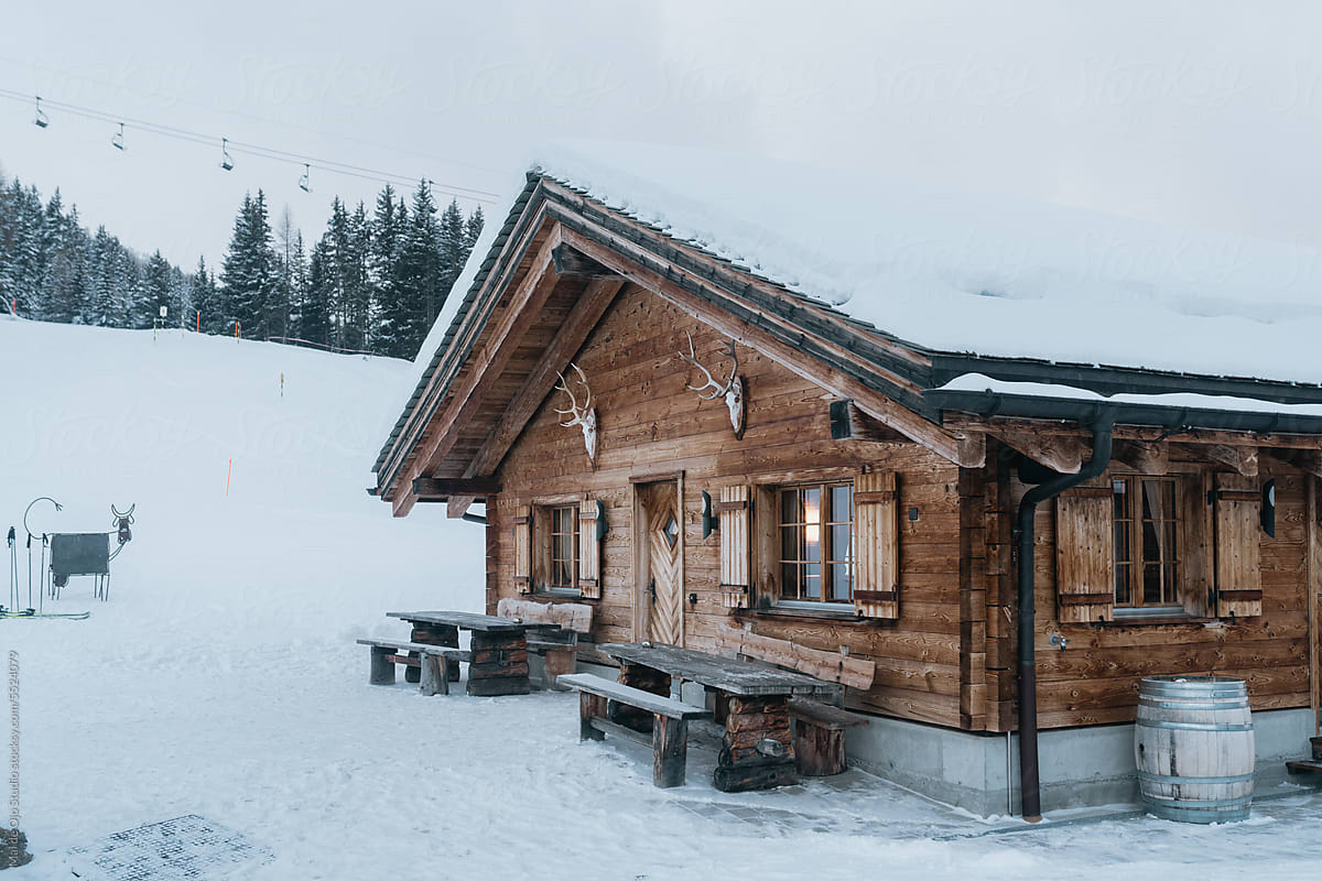 Wooden Cabin Covered in Snow