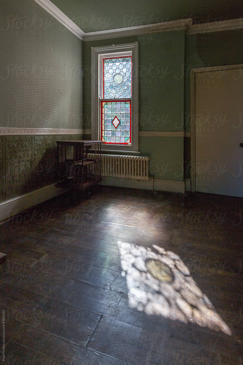 Corner Of A Room In An Old House With Sun Shining Through Stained Glass