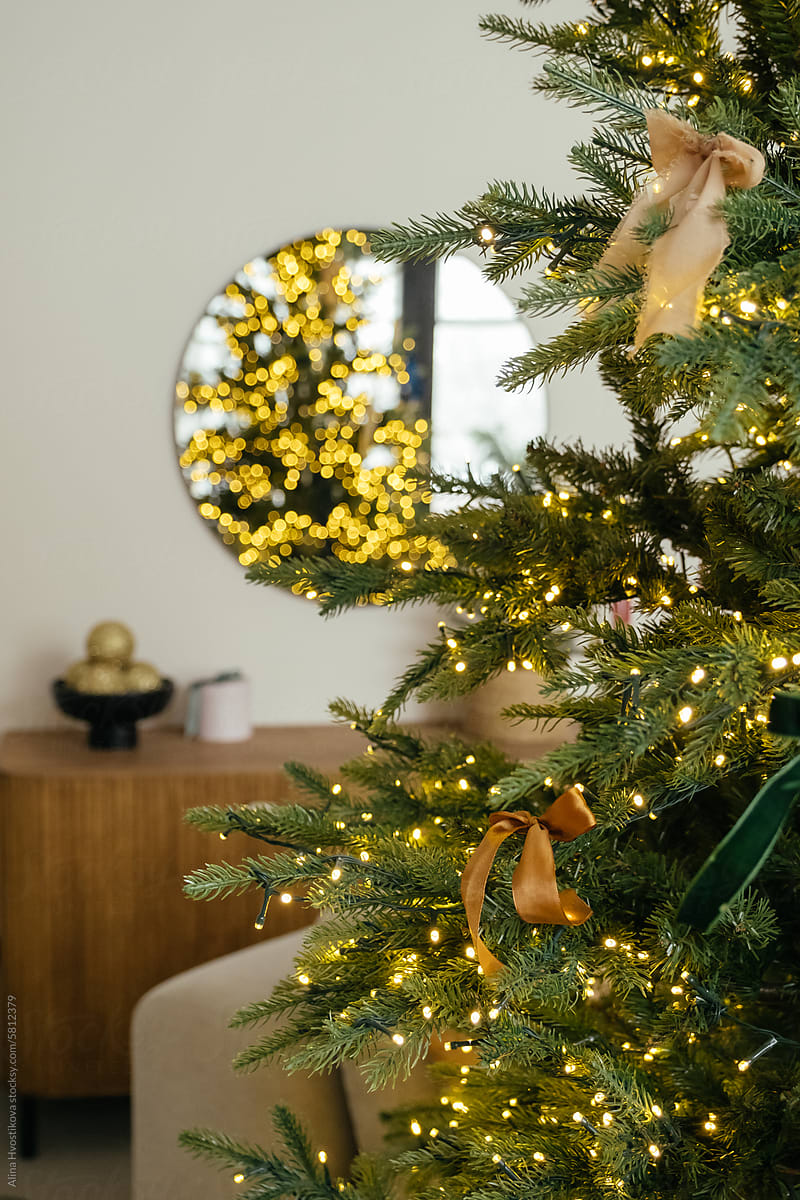 Christmas tree with garland near mirror