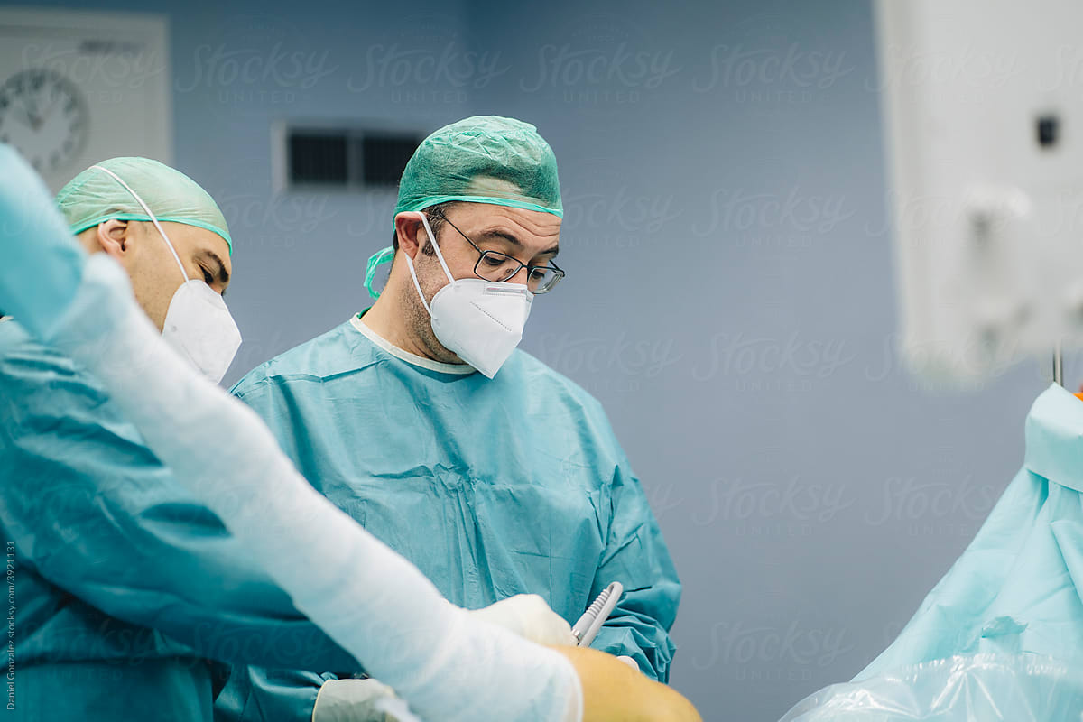 Surgeons operating patient in hospital
