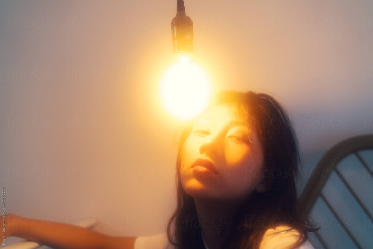 Asian female portrait with light bulb