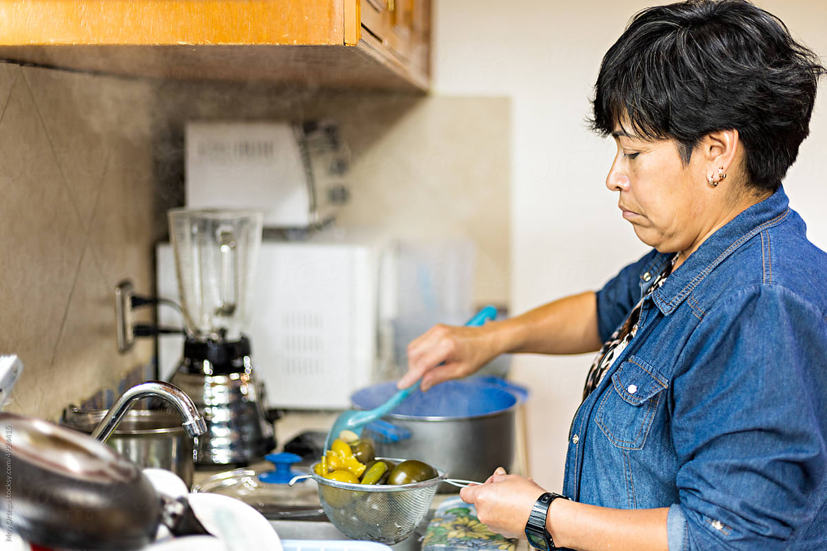 Woman draining vegetables for cooking