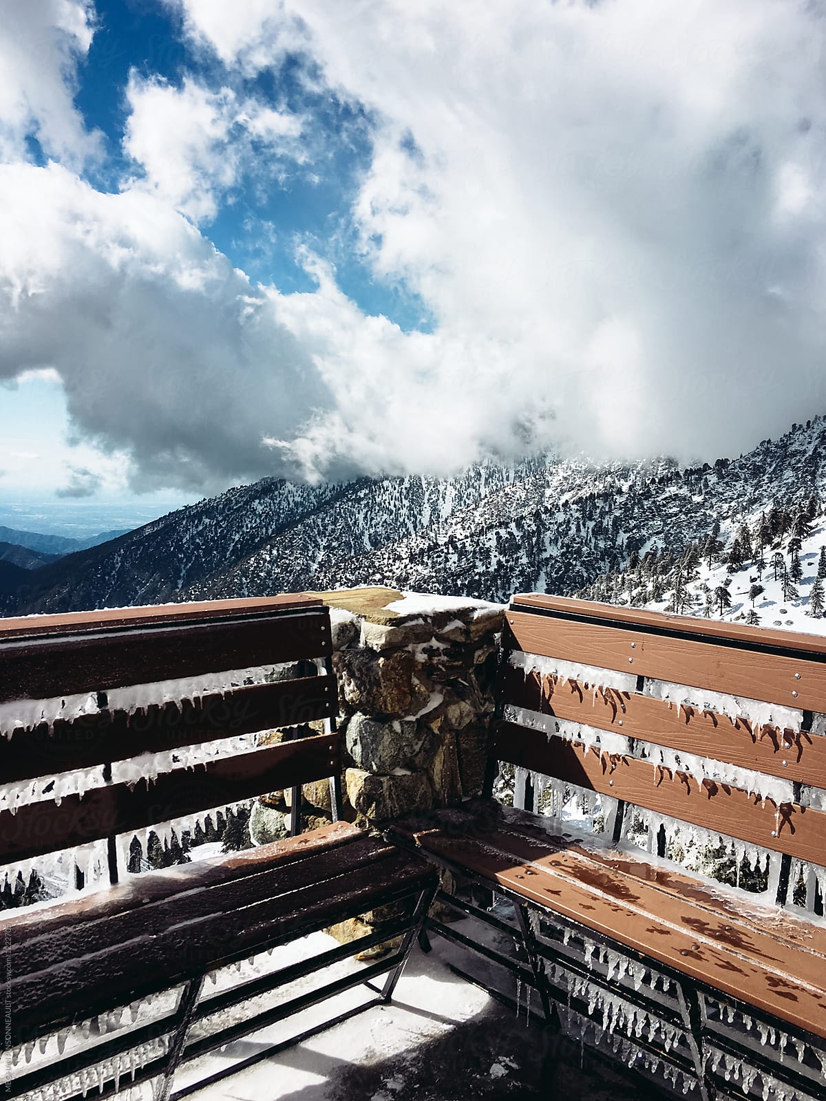 Icy Bench with Beautiful Snowy Mountain View