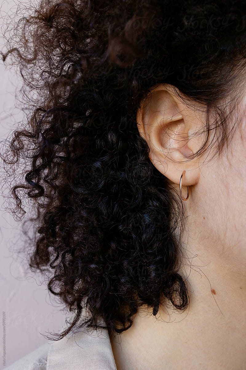 Close-Up of Womans Curly Hair and Ear
