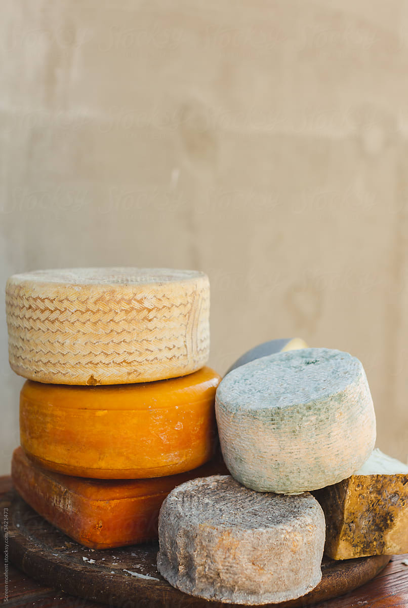 various types of cheese on a rustic table
