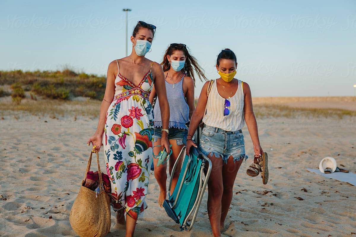 Walking on the beach with face masks