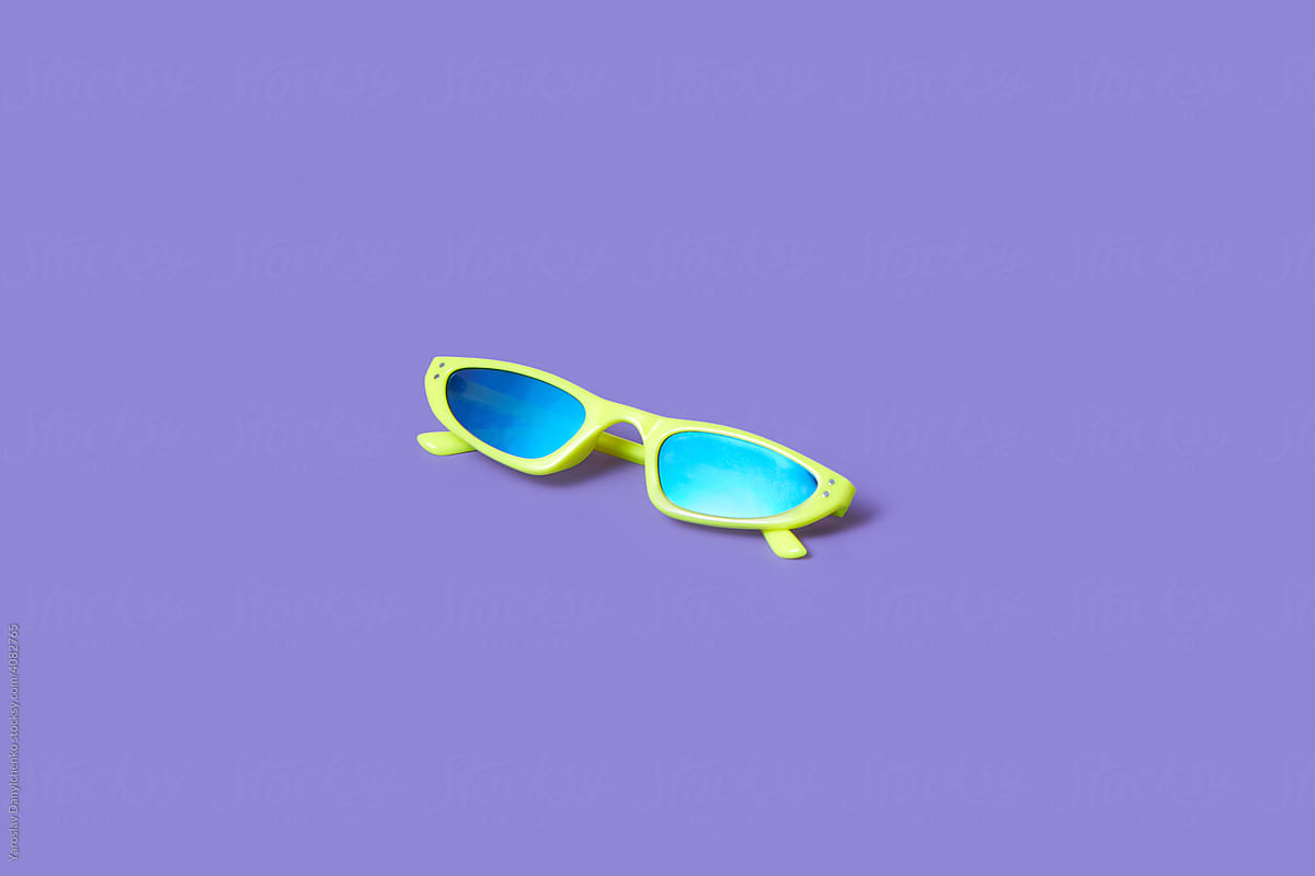 Stylish sunglasses over violet background
