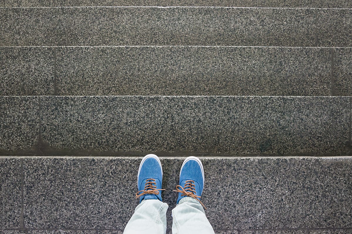 Blue sneakers on staircase, footsie, personal perspective