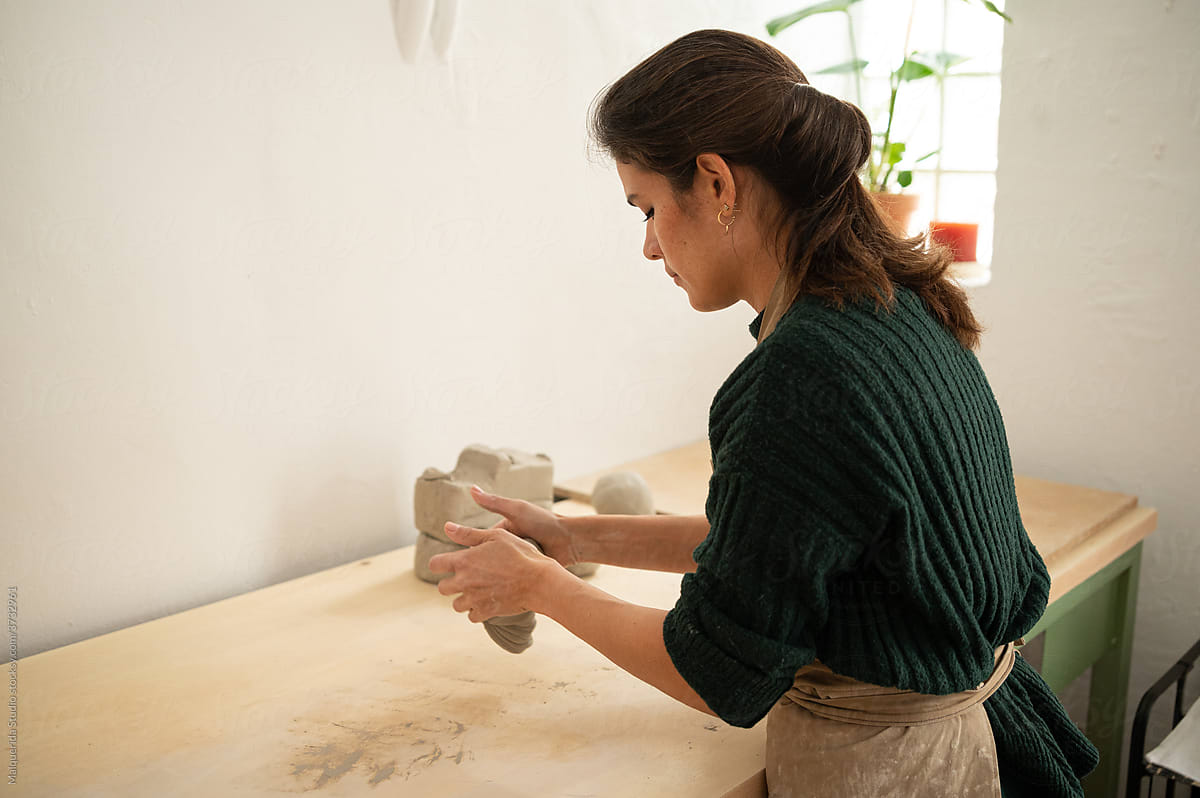 Ceramist kneading clay in the workshop