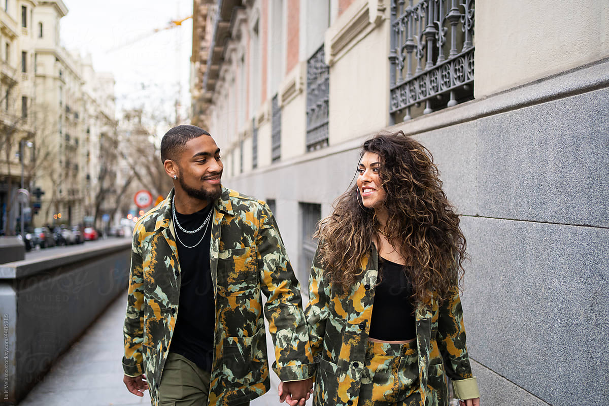 Mixed-Race Couple With Camouflage Fabric Clothes On the Street.