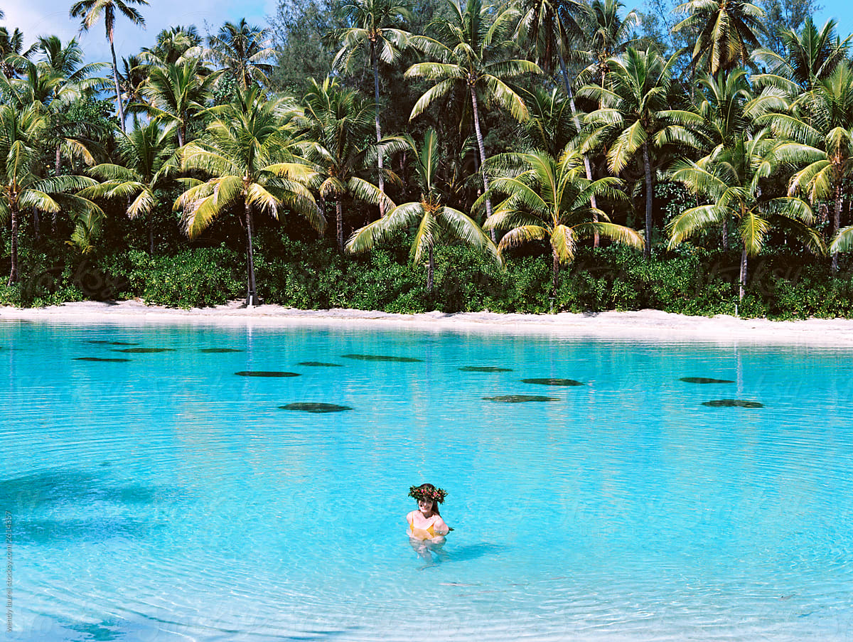 Film photo in Tahiti with blue and turquoise water and ocean and bright colored flowers