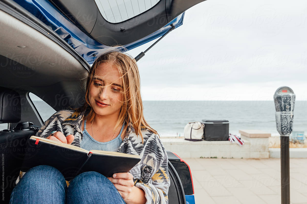 Blonde Woman Writes Near The Ocean By Stocksy Contributor Jayme