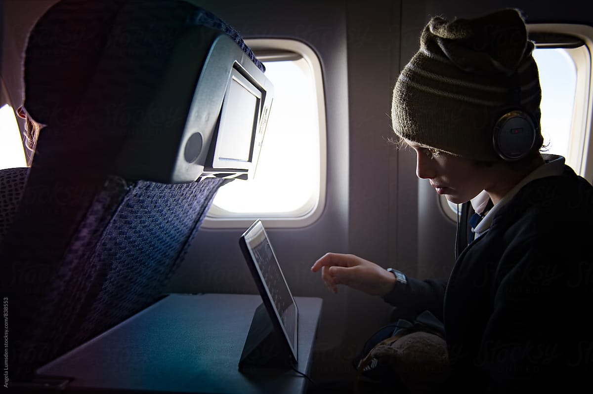 Boy watching a screen on an airplane