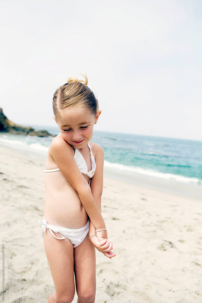 Shy Little Girl In Bathing Suit On Beach by Stocksy Contributor Dina  Marie Giangregorio - Stocksy