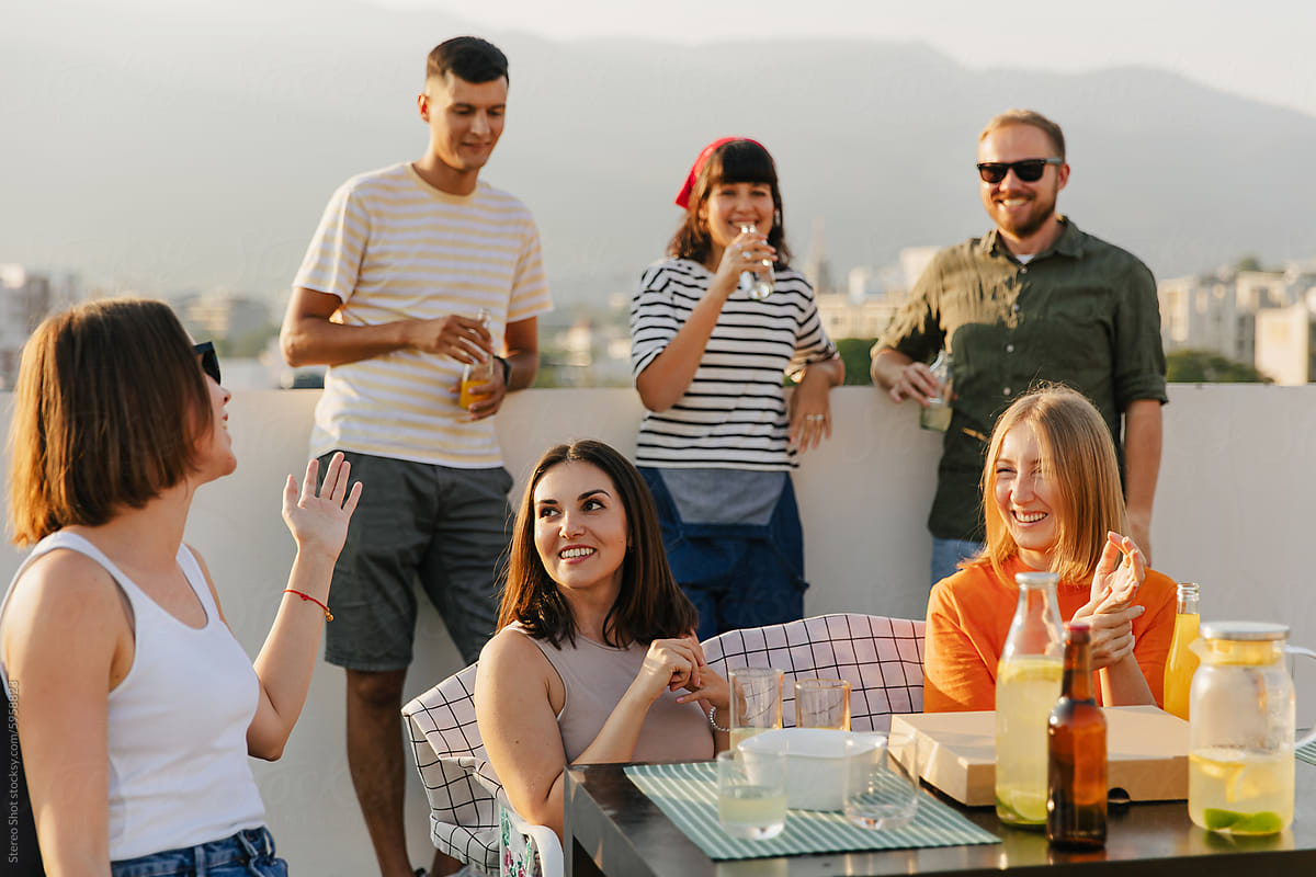 Group of friends enjoying party together on rooftop