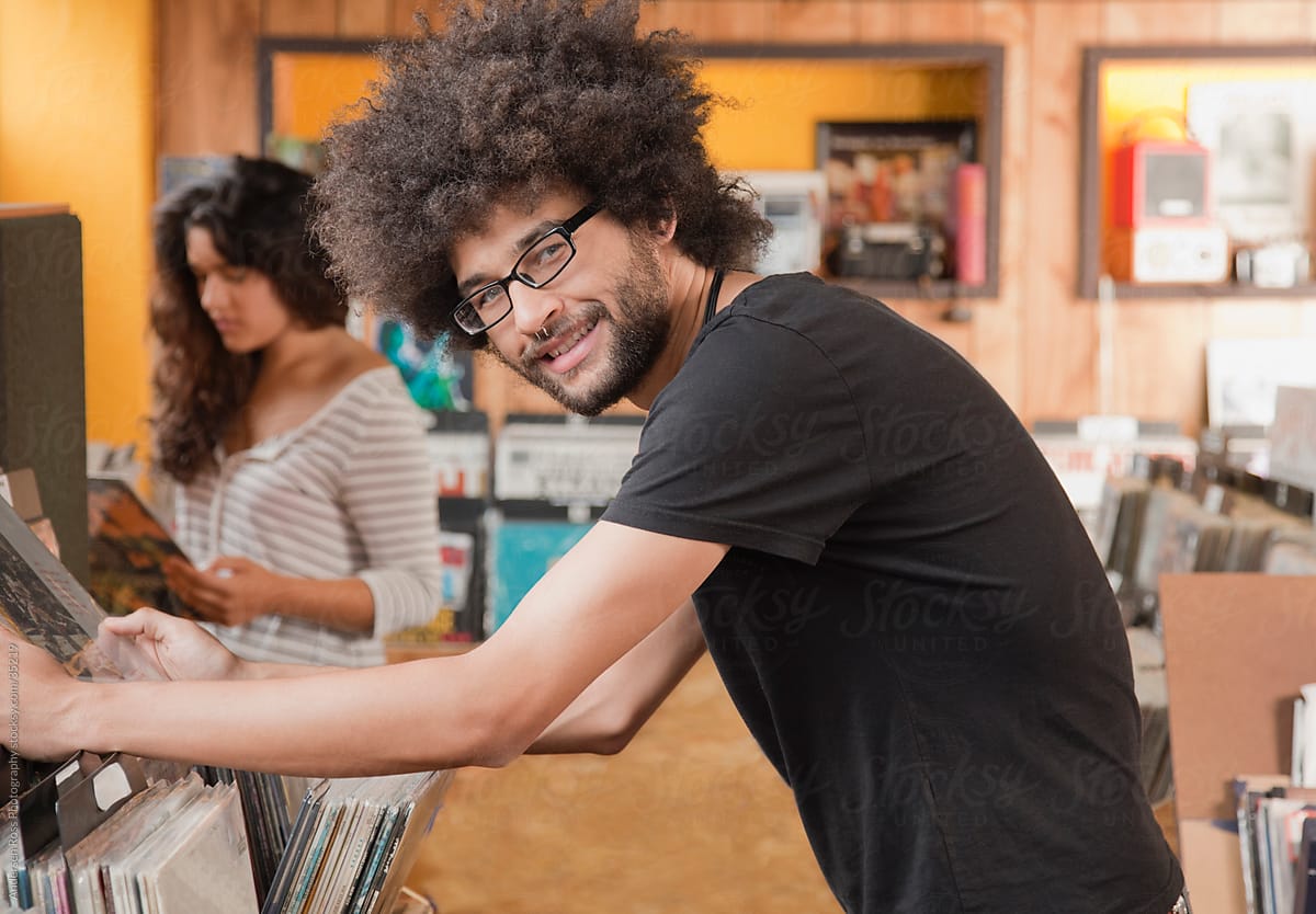 Portrait of young man browsing records at record shop