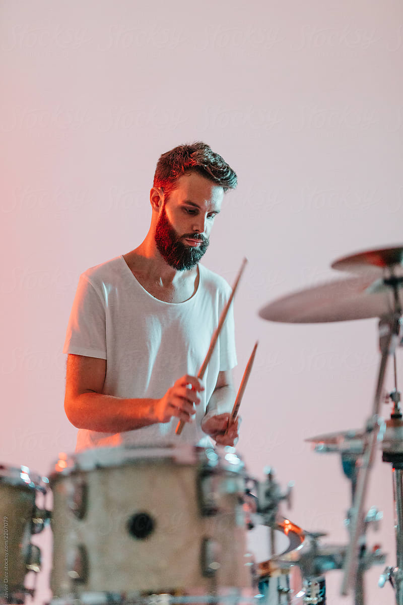 Man playing drums on white background