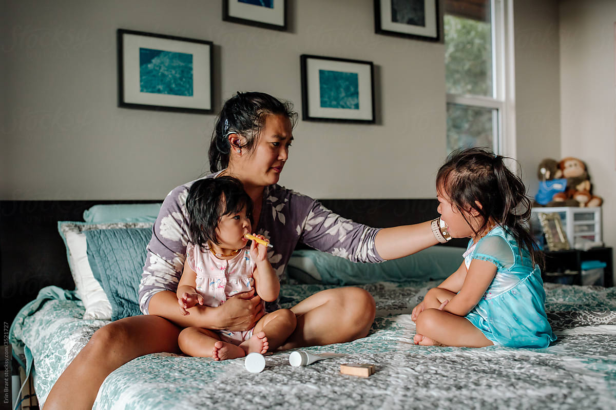 Asian deaf mother caring for sick daughters