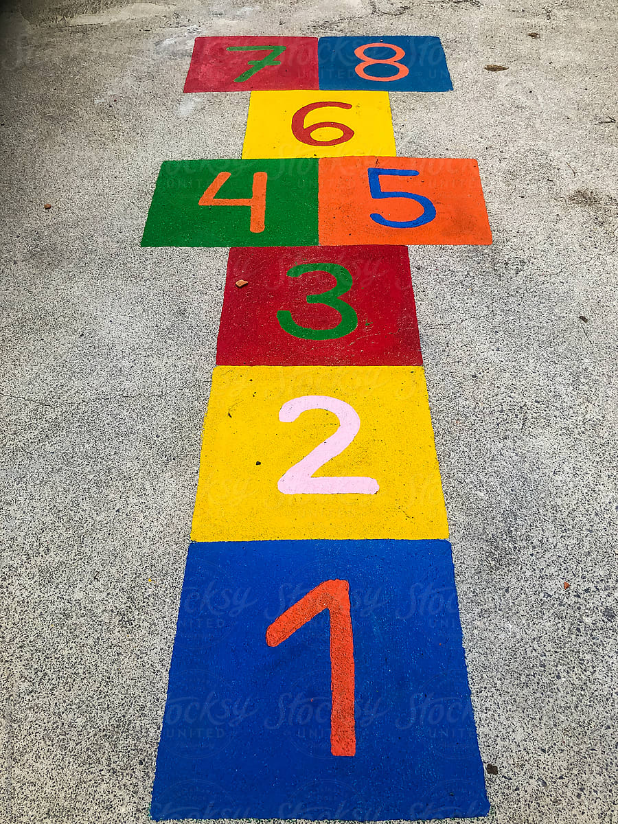 Colorful count and hop game squares painted on asphalt