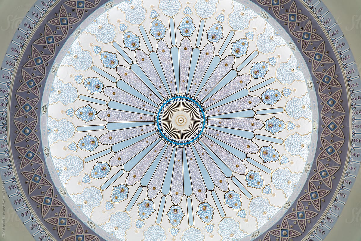 Looking up at the ceiling of a dome in a traditional Islamic building