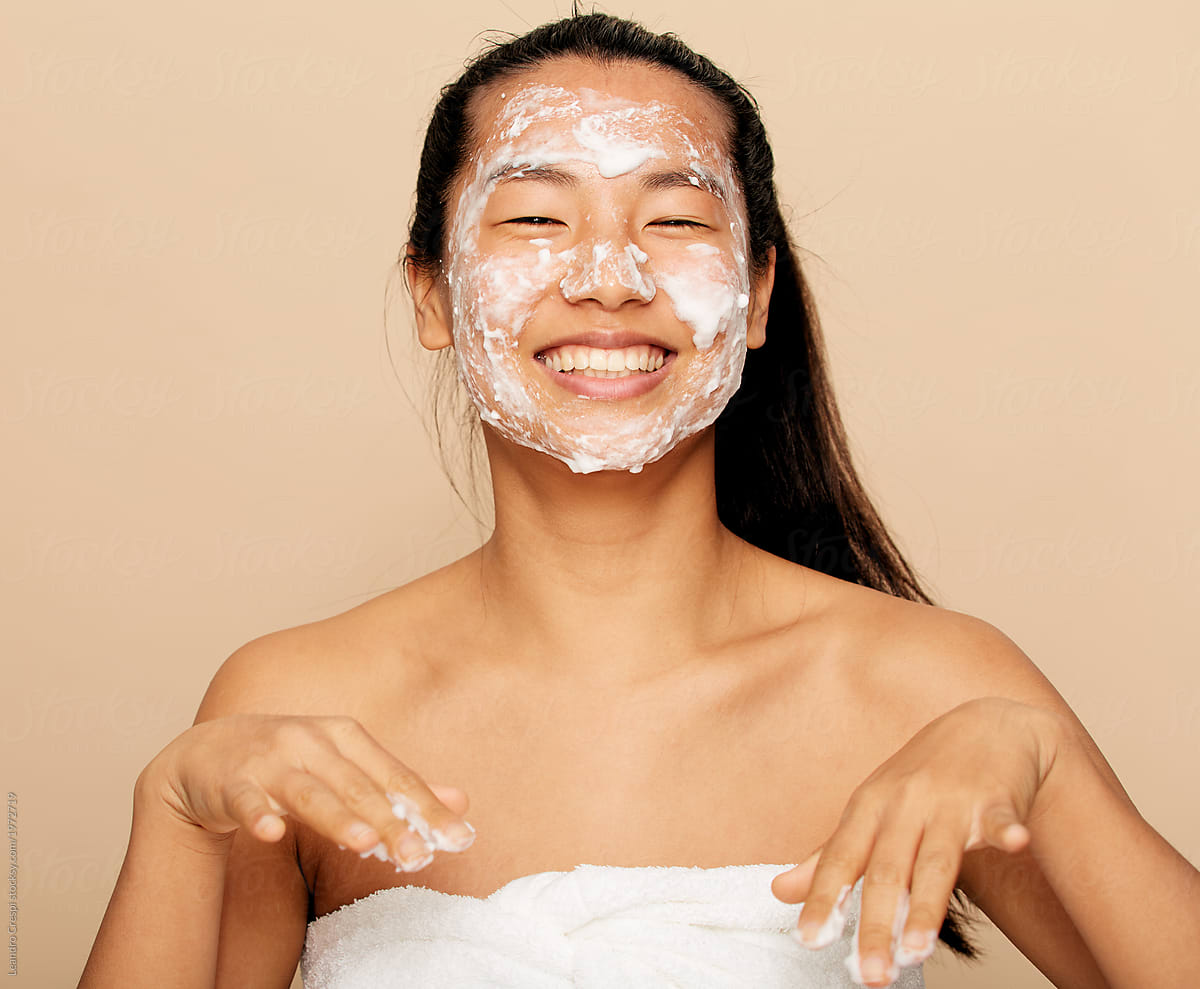Asian Woman laughing while face washing