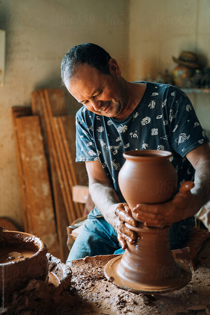 Man Works with Clay to Makes a Vase