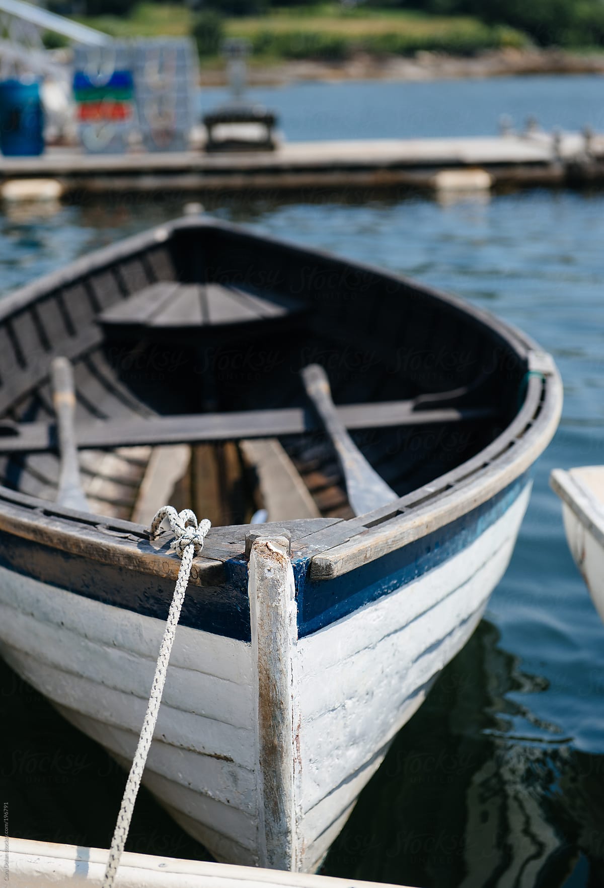 Old Wooden Dinghy Tied To A Dock by Stocksy Contributor Cara
