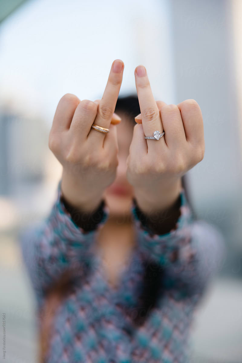 A Woman Raises Her Ring Finger.
