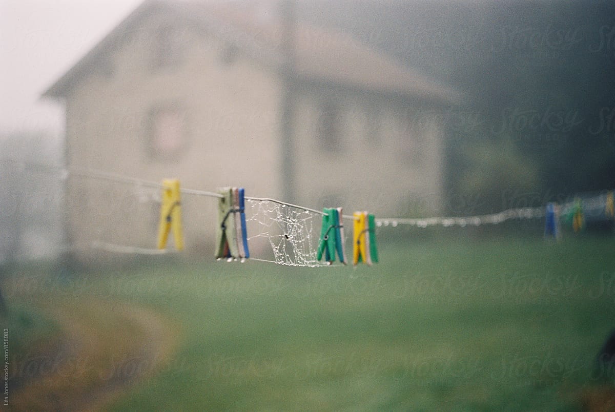 wet laundry line in front of farmhouse
