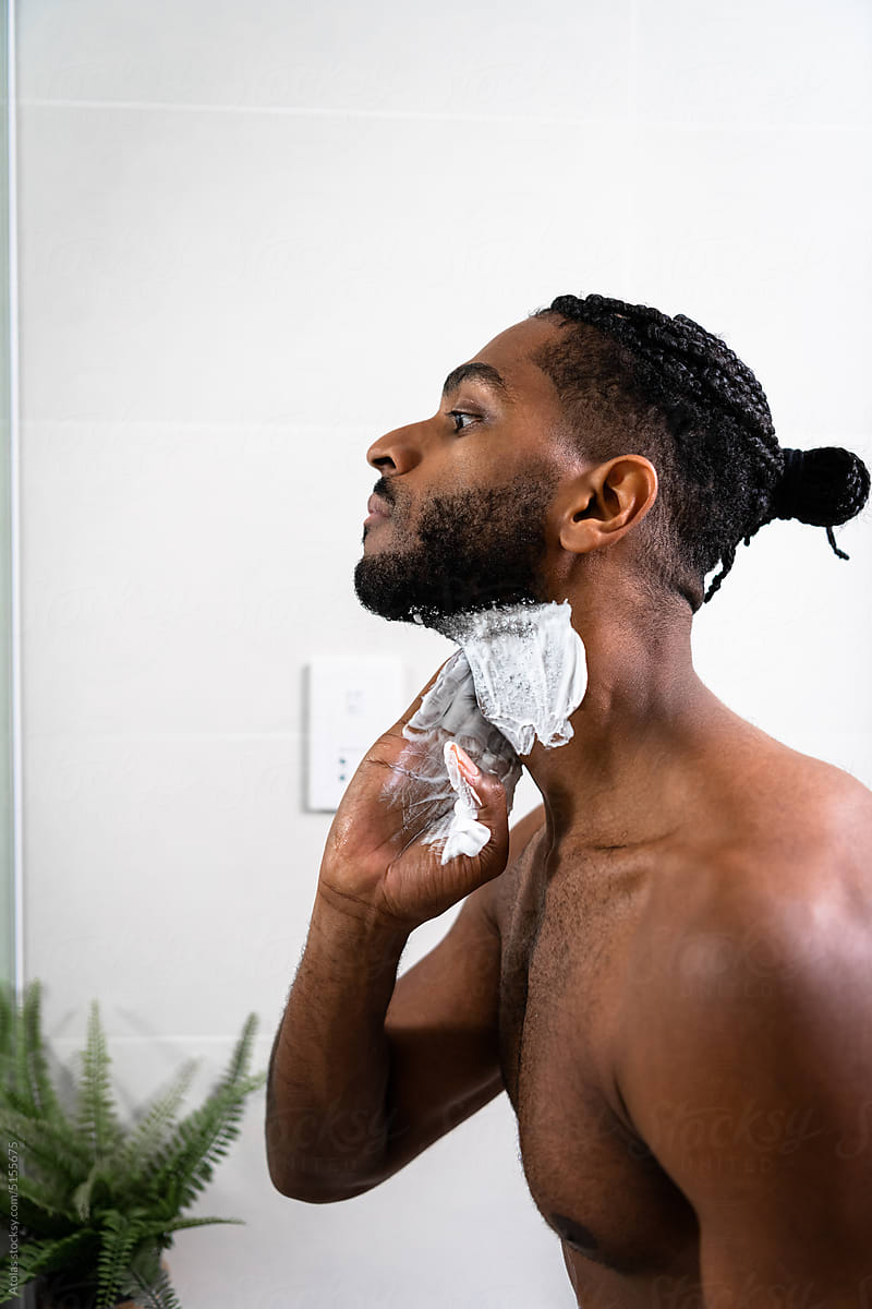Man applying shaving foam on face