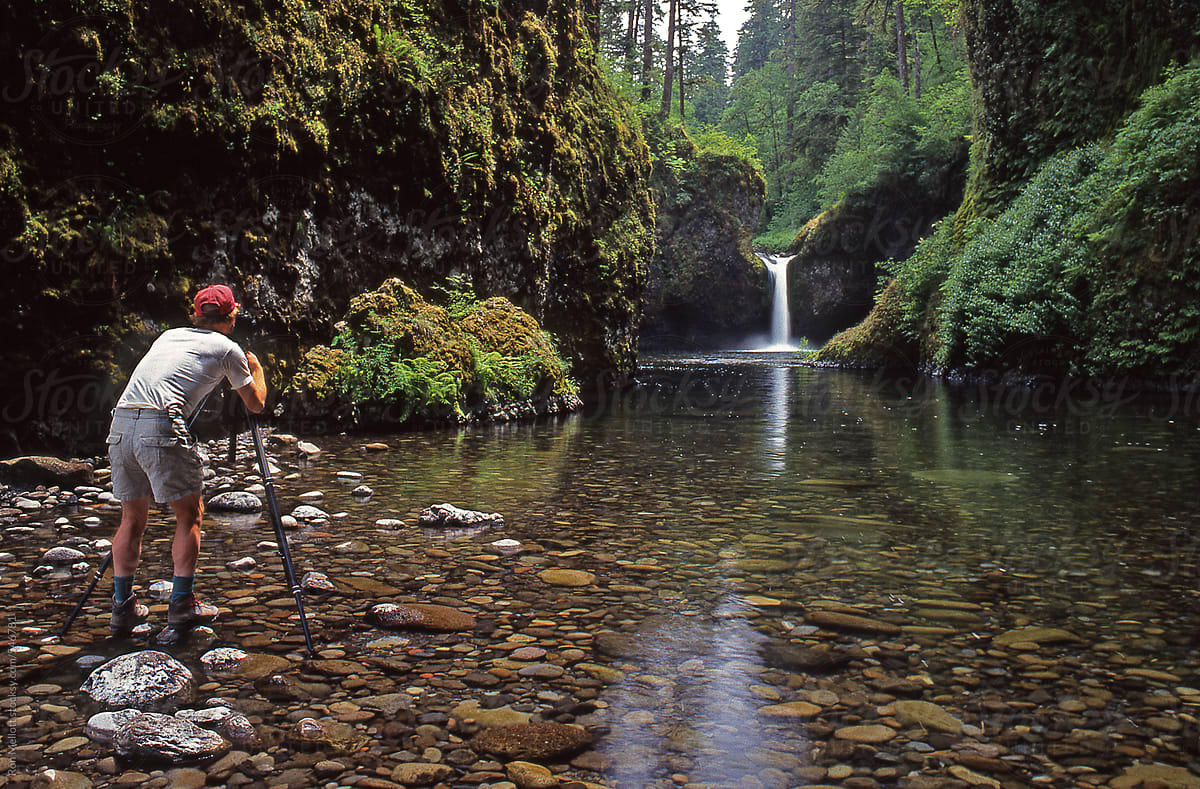 photographer at Punchbowl Falls in the Columbia River Gorge Eagle Creek waterfalls tripod