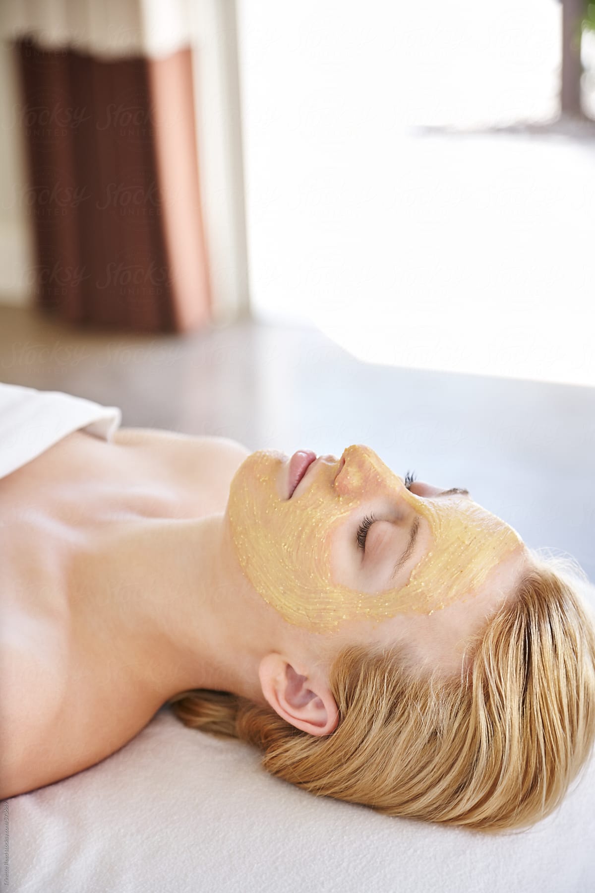 Woman resting with all natural facial at luxury spa