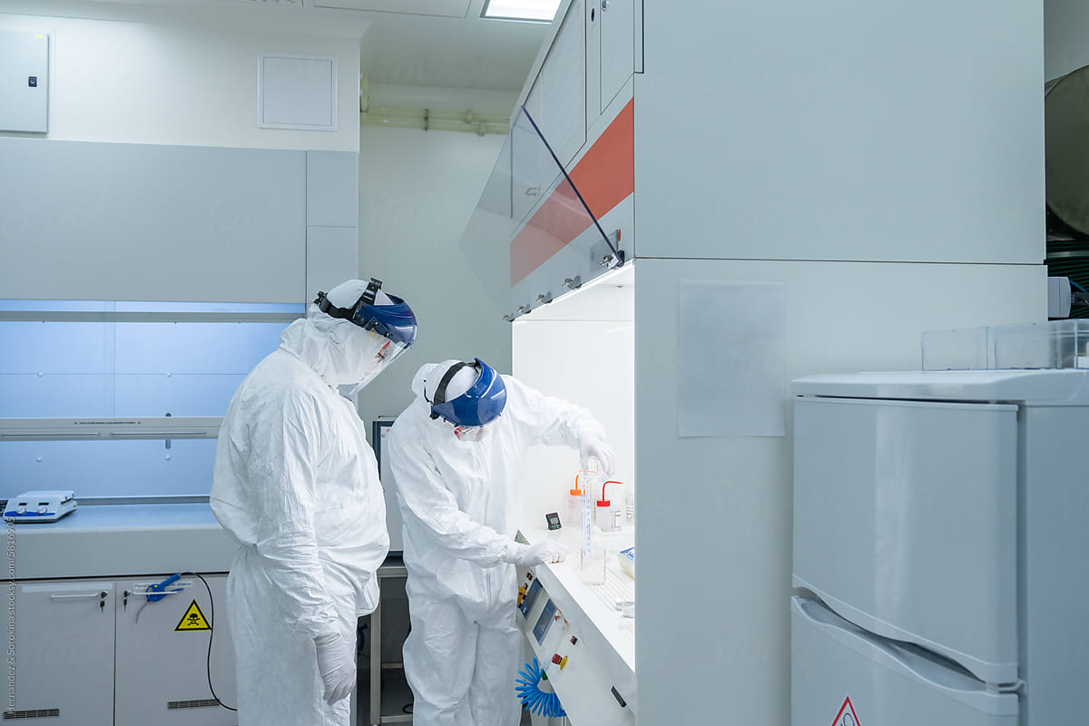 Two Scientists Working At Clean Room
