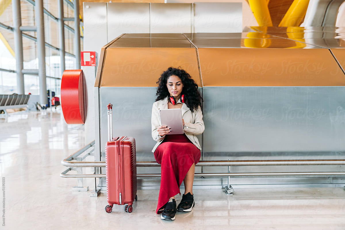 Woman using digital tablet in airport
