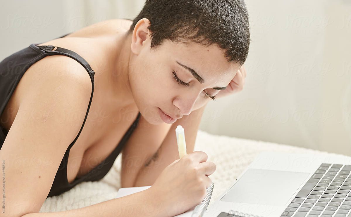 Serious millennial woman taking notes