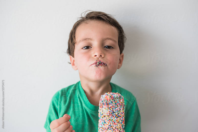 A Boy With Sprinkles On His Face Being Silly