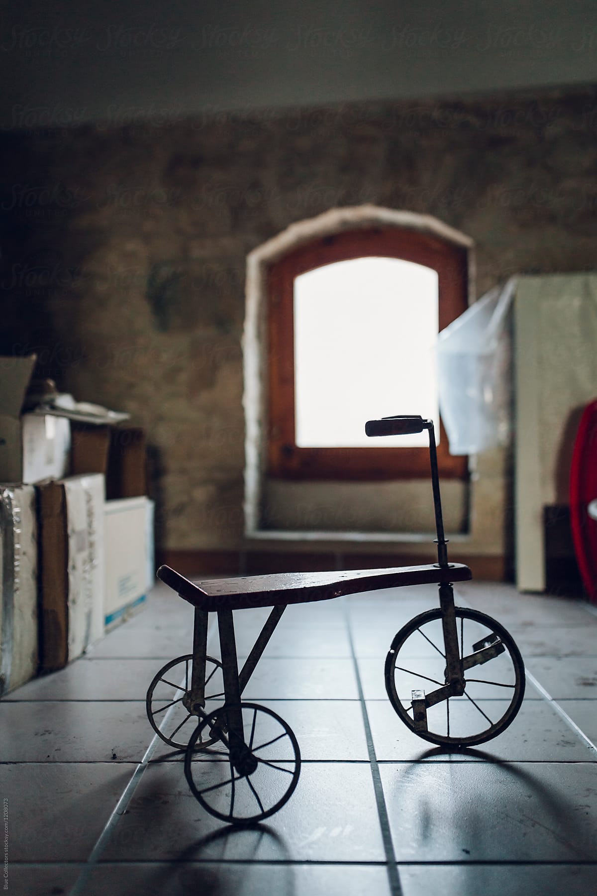 Old tricycle on a warehouse