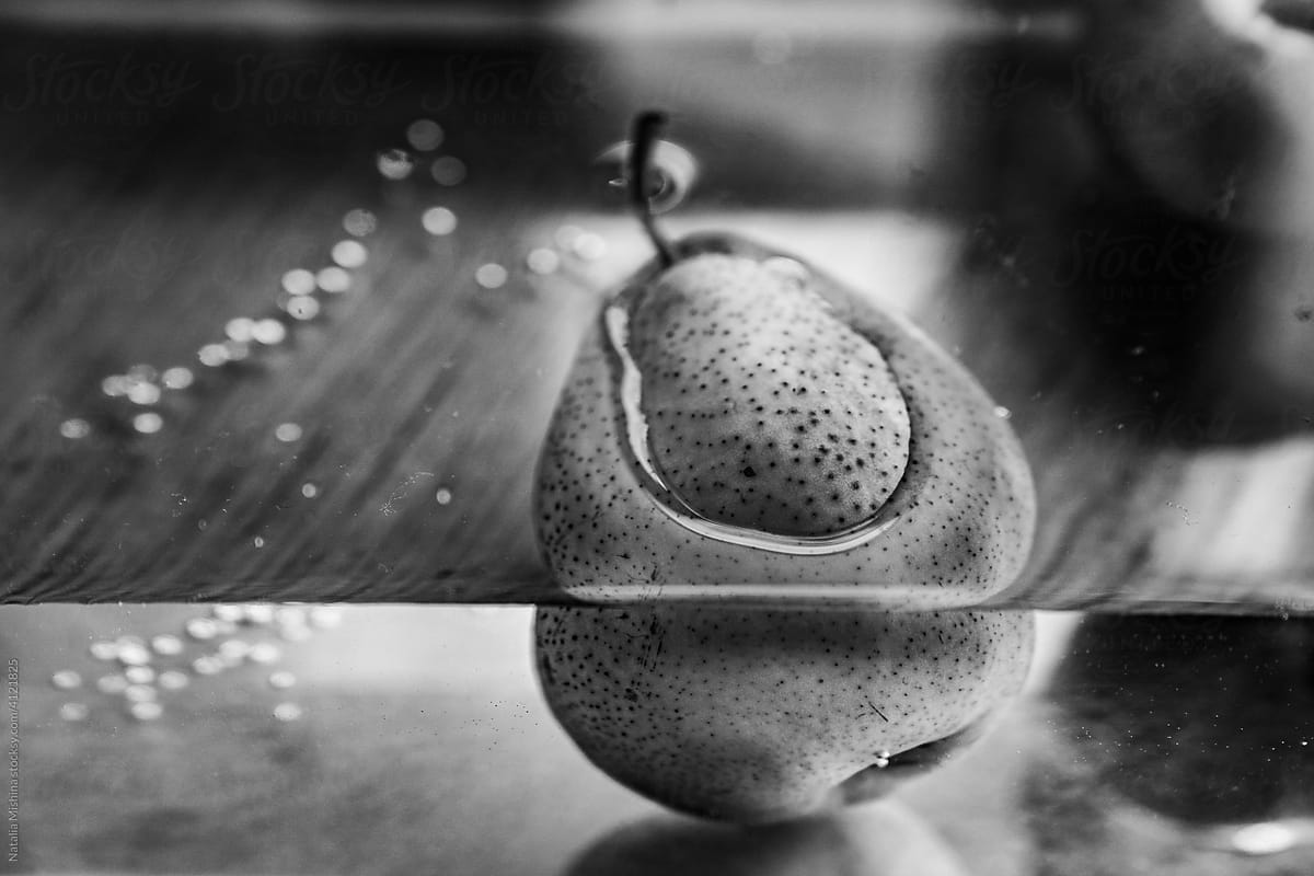 A ripe pear in a tank with water.