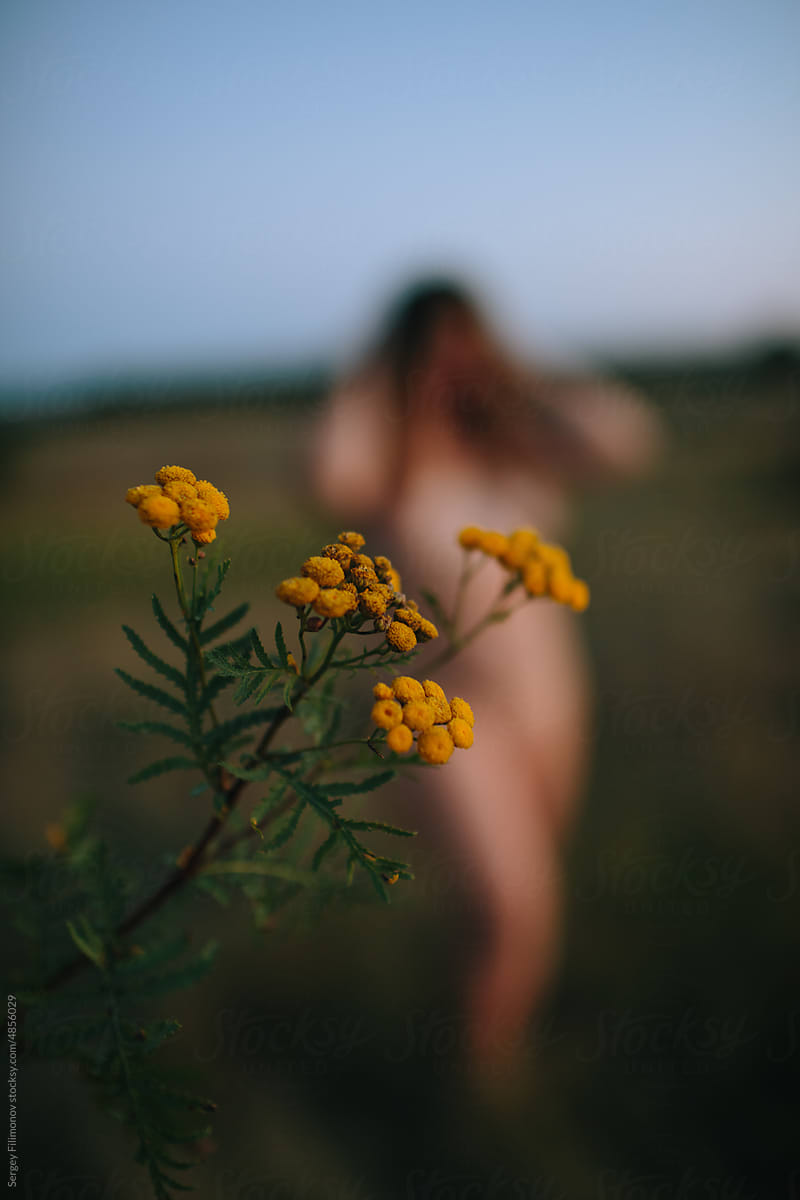 Yellow flowers and naked woman