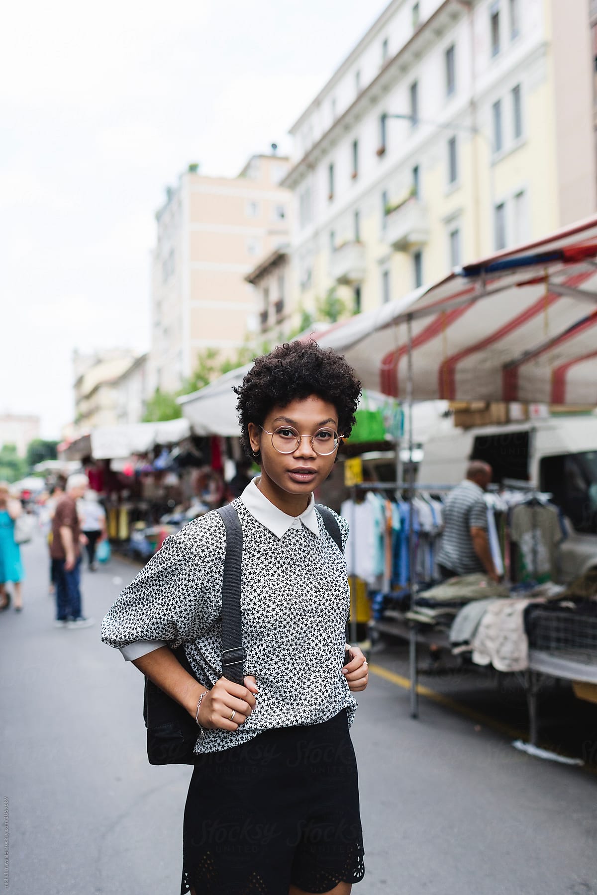 Portrait Of Beautiful Woman With Backpack At The Market Place Del
