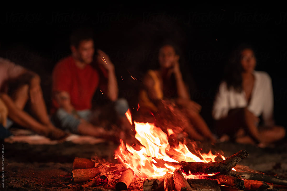 Group of friends around campfire
