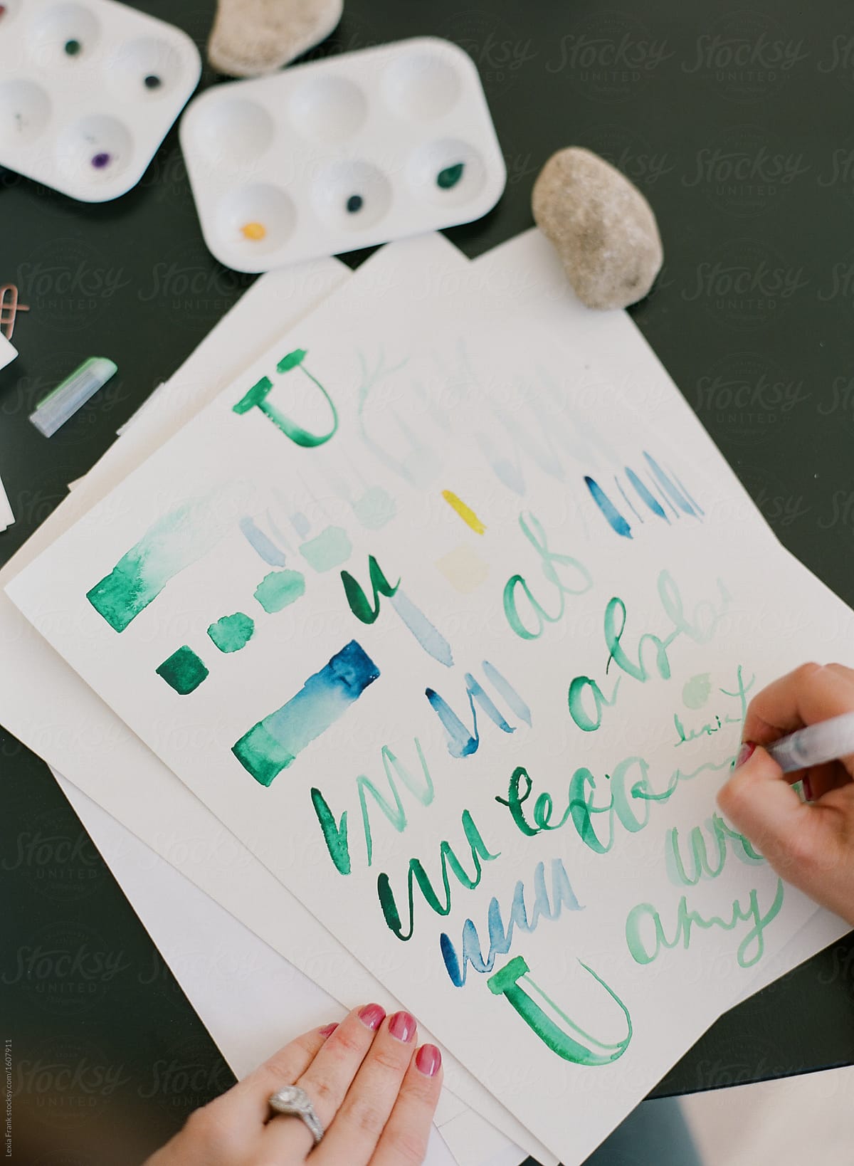 artists practice watercolor painting and hand lettering in outdoor classroom
