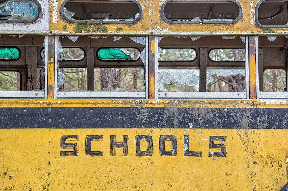 Abandoned school bus with broken windows