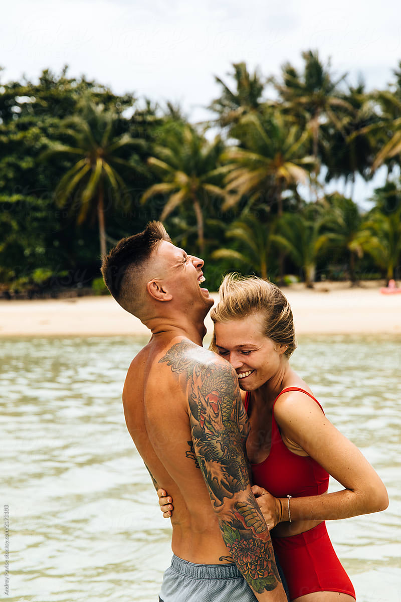 Portrait of laughing couple on the beach