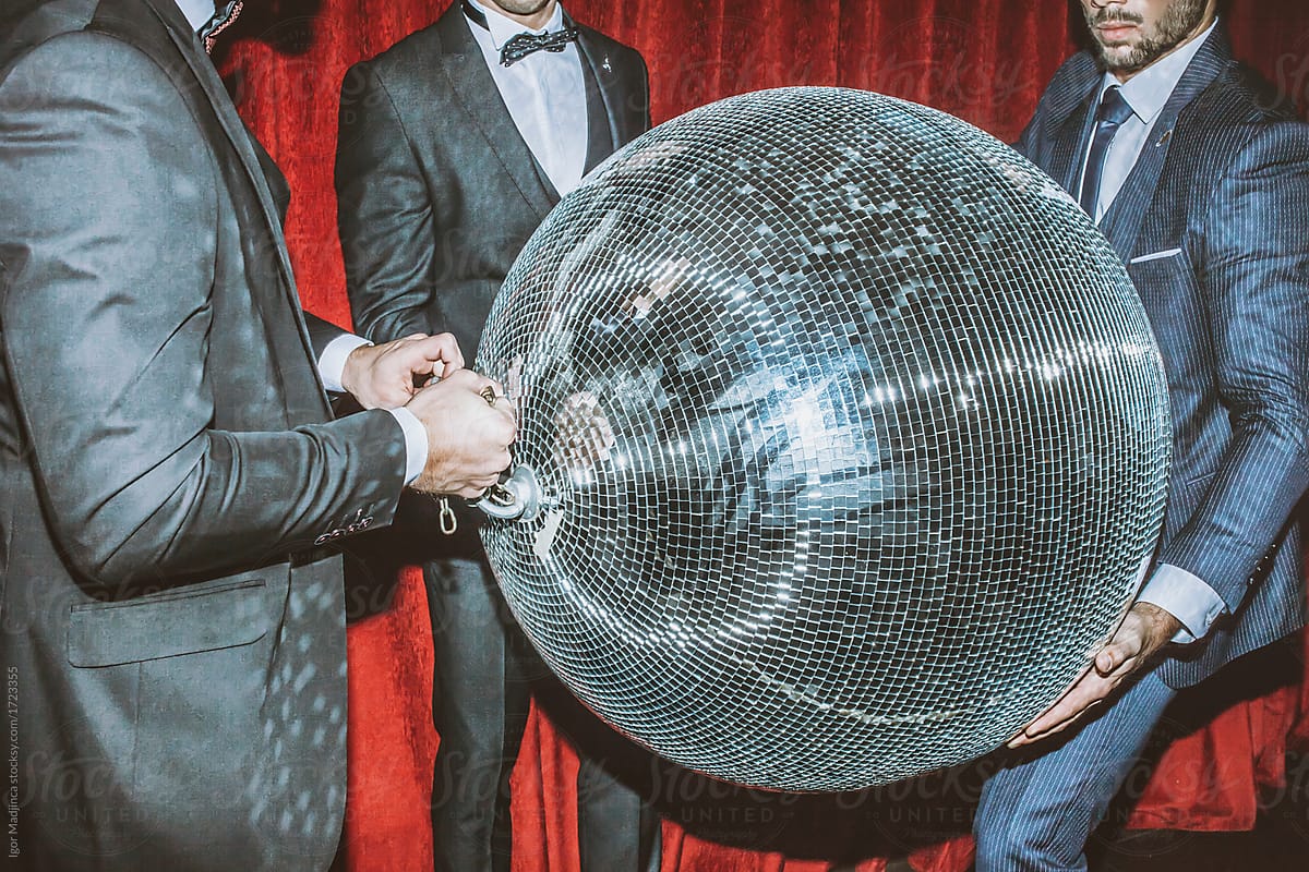 the guys in the suit play with the disco ball