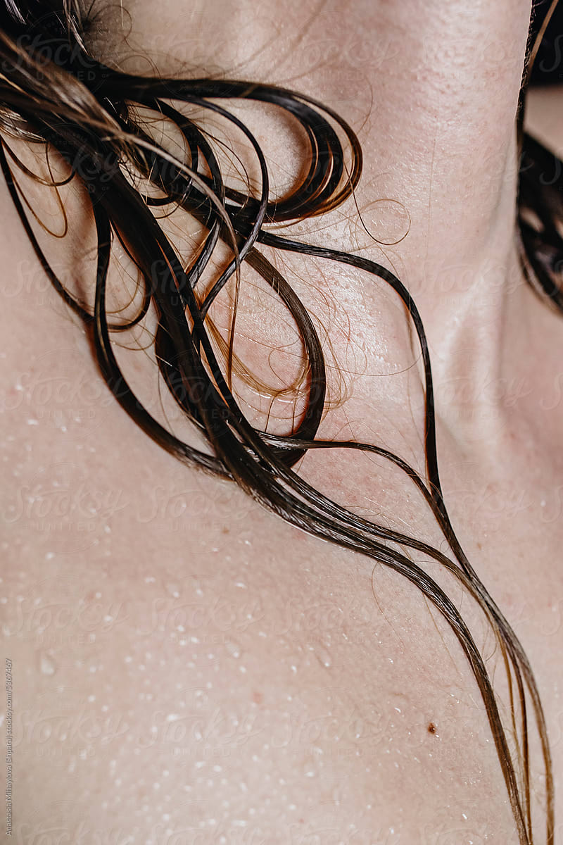 Closeup photo of woman\'s neck skin texture and wet hair on the skin
