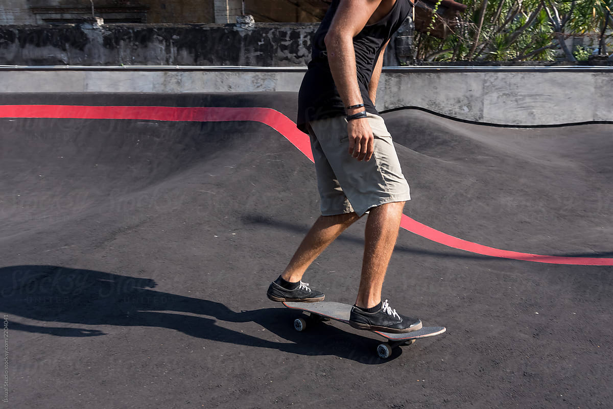 Skateboarder rides a pump track